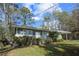 Side view of a cozy single-story home with a well-maintained lawn and mature landscaping at 3680 Larkspur Ter, Decatur, GA 30032