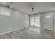Well-lit open concept area with sleek floors, a fan, and a sliding glass door at 3680 Larkspur Ter, Decatur, GA 30032