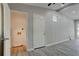 Spacious living room with gray walls, hardwood floors, and an open door to the laundry room at 3680 Larkspur Ter, Decatur, GA 30032