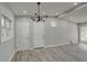 Bright living room featuring light gray walls, hardwood floors, modern lighting, and natural light at 3680 Larkspur Ter, Decatur, GA 30032