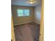 Bright bedroom with plush carpeting and natural light from the window at 3990 N Quail Dr, Douglasville, GA 30135