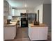 Well-lit kitchen featuring stainless steel appliances, white cabinets, and a butcher block island at 3990 N Quail Dr, Douglasville, GA 30135