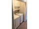 Convenient laundry area with modern washer, dryer, and built-in shelving for storage at 3990 N Quail Dr, Douglasville, GA 30135