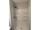 Updated shower stall with built-in shelving and a modern showerhead at 3990 N Quail Dr, Douglasville, GA 30135
