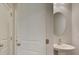 Powder room featuring pedestal sink and oval mirror at 4525 Twinberry Dr, Powder Springs, GA 30127