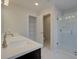 A bright bathroom features double sinks, a shower with glass doors, and a door leading to the toilet at 4525 Twinberry Dr, Powder Springs, GA 30127