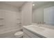 Bright bathroom featuring a tub-shower, a large mirror, and a white vanity with a modern sink at 4525 Twinberry Dr, Powder Springs, GA 30127