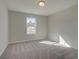 Bright bedroom featuring neutral carpet, light walls, and a window offering natural light at 4525 Twinberry Dr, Powder Springs, GA 30127