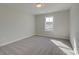 Cozy bedroom with neutral carpet, a ceiling fan, and a window offering natural light at 4525 Twinberry Dr, Powder Springs, GA 30127