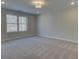 Expansive bedroom with a large window offering outside views and neutral carpet at 4525 Twinberry Dr, Powder Springs, GA 30127