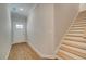 Bright entryway with wood floors, featuring a staircase and a view of the front door at 4525 Twinberry Dr, Powder Springs, GA 30127
