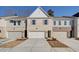 Charming townhome with a two-car garage and brick and siding facade, set on a sunny day at 4525 Twinberry Dr, Powder Springs, GA 30127