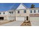 Attractive townhome with white brick, two car garage, and complementary architectural accents at 4525 Twinberry Dr, Powder Springs, GA 30127