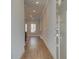 Inviting hallway with gleaming wood floors leading to a bright living area with natural light at 4525 Twinberry Dr, Powder Springs, GA 30127