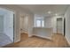 A spacious hallway features wood-look flooring, white trim, and access to the laundry and closet at 4525 Twinberry Dr, Powder Springs, GA 30127