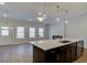 Open concept kitchen with stainless steel appliances, island, and view of living area and fireplace at 4525 Twinberry Dr, Powder Springs, GA 30127