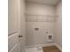 A tidy laundry room with essential hookups, a wire shelf, and a utility sink space at 4525 Twinberry Dr, Powder Springs, GA 30127