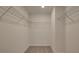 An empty walk-in closet with wire shelving and neutral carpeting offers organized storage space at 4525 Twinberry Dr, Powder Springs, GA 30127