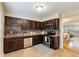 Well-appointed kitchen featuring granite countertops, stainless steel appliances, and dark wood cabinetry at 6980 Roswell Rd # G3, Atlanta, GA 30328