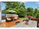 Inviting backyard with a wooden deck, seating, and lush greenery for relaxation and entertainment at 120 Candler Oaks Ln, Decatur, GA 30030