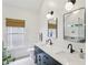 A modern bathroom features a double vanity, sleek lighting, and a window, offering a refreshing and bright space at 120 Candler Oaks Ln, Decatur, GA 30030
