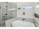 A bathroom is decorated with hexagonal tiles and features a modern soaking tub with a glass-enclosed shower at 120 Candler Oaks Ln, Decatur, GA 30030