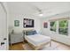 Cozy bedroom with natural light featuring hardwood floors and a ceiling fan at 120 Candler Oaks Ln, Decatur, GA 30030