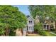 Two-story home with gray siding, brick accents, and mature trees, offering curb appeal at 120 Candler Oaks Ln, Decatur, GA 30030