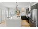 The kitchen has a spacious white quartz countertop island with room for seating and stainless steel appliances at 120 Candler Oaks Ln, Decatur, GA 30030