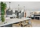A kitchen features a large quartz island, stainless appliances, and a cozy dining nook with a fireplace at 120 Candler Oaks Ln, Decatur, GA 30030