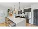 Modern kitchen with a large center island, stainless steel appliances, and white subway tile backsplash at 120 Candler Oaks Ln, Decatur, GA 30030