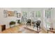 The sunroom has windows with shutters that allow sunlight in, and it's decorated with a cowhide rug and plants at 120 Candler Oaks Ln, Decatur, GA 30030