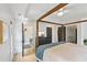The bedroom has a four-poster bed, with light colored bedding and a ceiling fan. It has access to the bathroom at 120 Candler Oaks Ln, Decatur, GA 30030