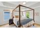 A bedroom features a four-poster bed, with plenty of natural light, and stylish decor, creating a cozy retreat at 120 Candler Oaks Ln, Decatur, GA 30030
