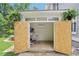Modern outdoor office shed featuring an air conditioner, desk, and stool at 120 Candler Oaks Ln, Decatur, GA 30030
