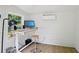 Bright shed interior with desk, computer, adjustable stool, and air conditioning unit at 120 Candler Oaks Ln, Decatur, GA 30030