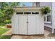 Outdoor storage shed with double doors, transom windows, and green plants at 120 Candler Oaks Ln, Decatur, GA 30030