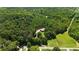 A high aerial view of a cozy cabin surrounded by lush forests, demonstrating the private setting at 154 Knucklesville Rd, Rydal, GA 30171