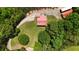 Bird's eye view of a home with a metal roof, a winding driveway, and lush landscaping at 154 Knucklesville Rd, Rydal, GA 30171