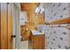 Bathroom featuring wood-paneled walls and a single-sink vanity at 154 Knucklesville Rd, Rydal, GA 30171