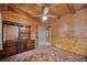 Bedroom with wood-paneled walls and ceiling features a ceiling fan and built-in storage at 154 Knucklesville Rd, Rydal, GA 30171