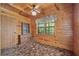 Cozy bedroom featuring wood-paneled walls and natural light from the windows at 154 Knucklesville Rd, Rydal, GA 30171