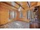 Bedroom featuring wood-paneled walls and ceiling with a ceiling fan and natural light from the windows at 154 Knucklesville Rd, Rydal, GA 30171