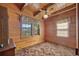Cozy bedroom featuring wood-paneled walls, carpet flooring, and natural light from the windows at 154 Knucklesville Rd, Rydal, GA 30171