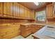 Traditional kitchen with wooden cabinets and wood paneling at 154 Knucklesville Rd, Rydal, GA 30171