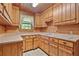 Traditional kitchen with wooden cabinets and wood paneling at 154 Knucklesville Rd, Rydal, GA 30171