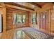 Charming living area with hardwood floors, wood paneled walls and windows dressed with light and airy curtains at 154 Knucklesville Rd, Rydal, GA 30171