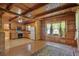 Cozy living room features wood-paneled walls, ceiling beams, and large windows at 154 Knucklesville Rd, Rydal, GA 30171