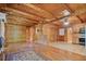 Charming living room featuring wood walls, ceiling fan, and hardwood floors at 154 Knucklesville Rd, Rydal, GA 30171
