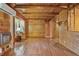 Spacious living room featuring wood paneling, hardwood floors, and abundant natural light for a cozy feel at 154 Knucklesville Rd, Rydal, GA 30171